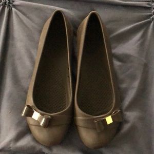 Brown crocs with gold bow